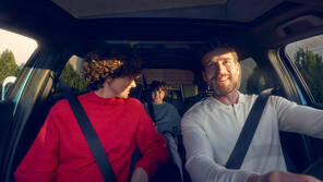 Family sitting in Honda vehicle.