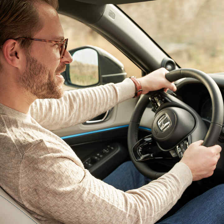 Man holding steering wheel. 