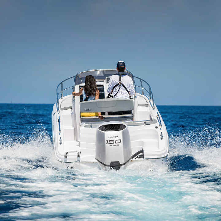 Couple on a boat using a Honda BF150 engine in ocean location.