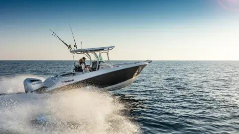 Couple on a boat with Honda engine in water location.