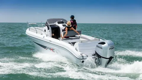 Couple on a boat with Honda BF200 engine. 