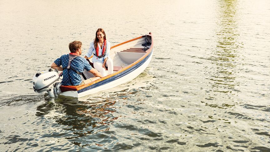 Couple on boat with a Honda BF6 engine. 