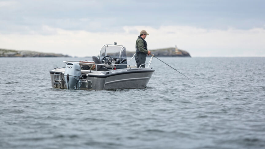 A range of Honda BF60 engines on back of boats in the water. 