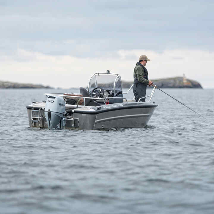 Gentleman on a boat with Honda BF60 engine in ocean location. 