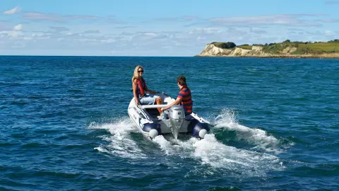 Models driving a boat with an BF8-10 engine in a sea location.