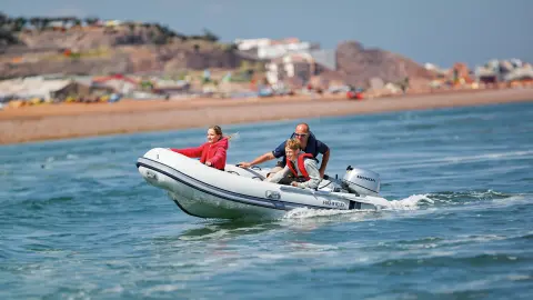 Family on a boat in the sea using BF8-10 engine.