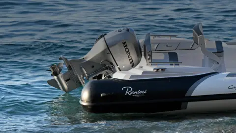 Close up of the Honda BF80-100 engine at the back of the boat in a sea location.