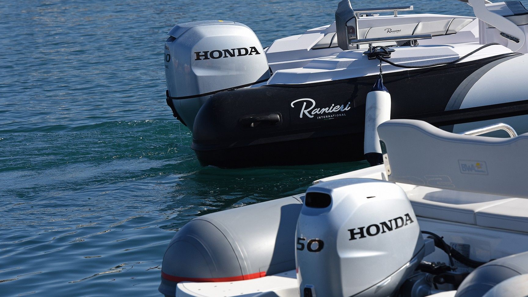 Close up of Honda BF50 at the back of the boat in a sea location.