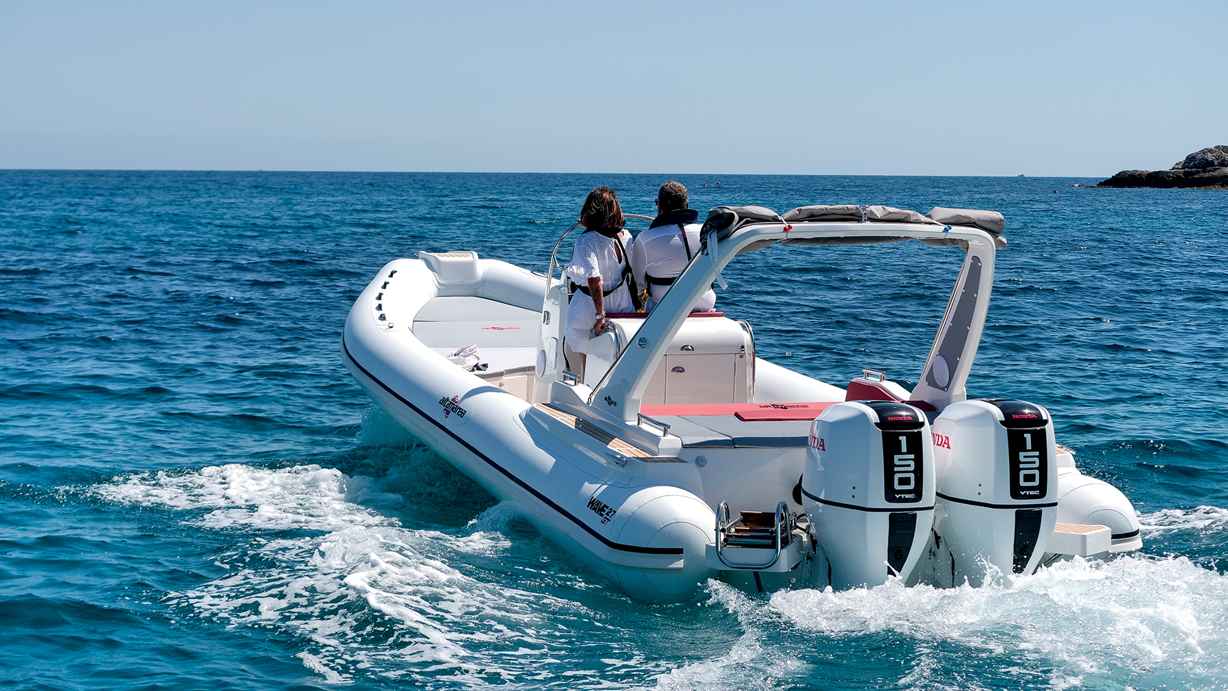 Passengers sitting on a speedboat with two engines