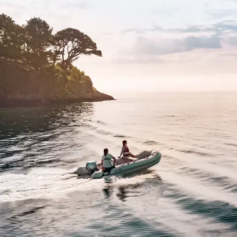 Boat in water with sunset in background