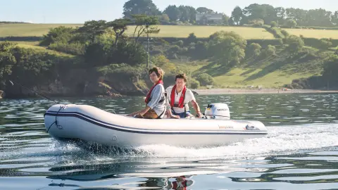 Boat in water with sceneic greenery in background