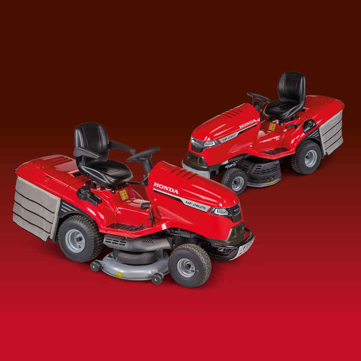 Honda Ride-On mower and Honda Tractor on grass on a dark background