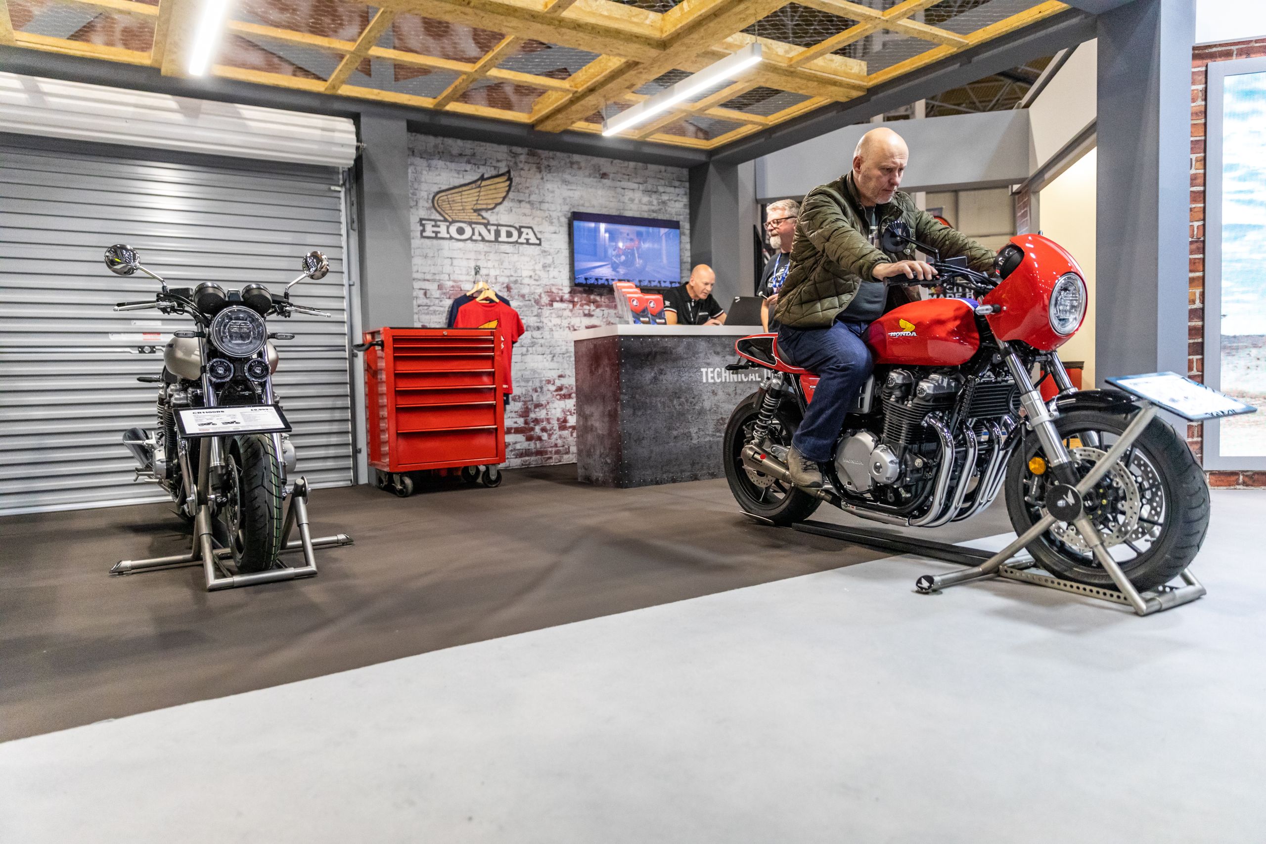 Event attendee sat on Honda street motorbike on the stand at Motorcycle Live 2019