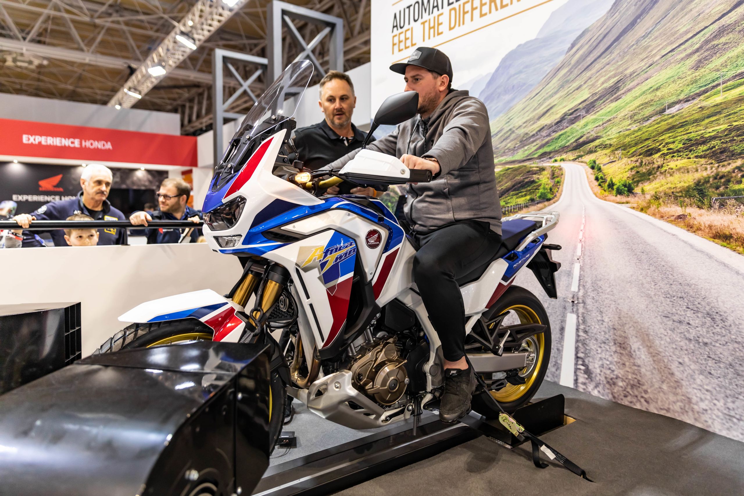 Event attendee sat on 2020 Honda Africa Twin Adventure Sports motorcycle at Motorcycle Live 2019