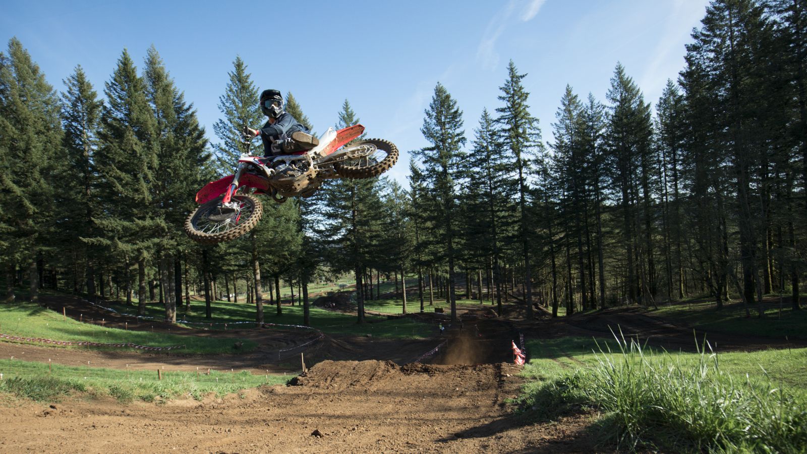Rider mid-jump riding a Honda CRF450R